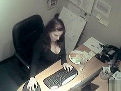 Busty business woman fucks a carrot at work