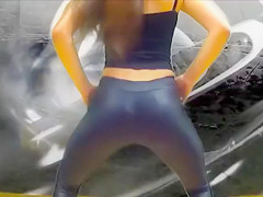 teen 18+ Latina dancing and singing in a parking lot