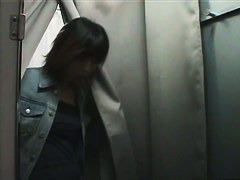 An asian cutie gets onto the changing room unaware of the