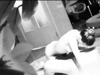 Blonde girl massages bald man who is playing with her cell